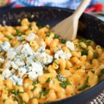 Buffalo Chicken Pasta with crumbled blue cheese on top.