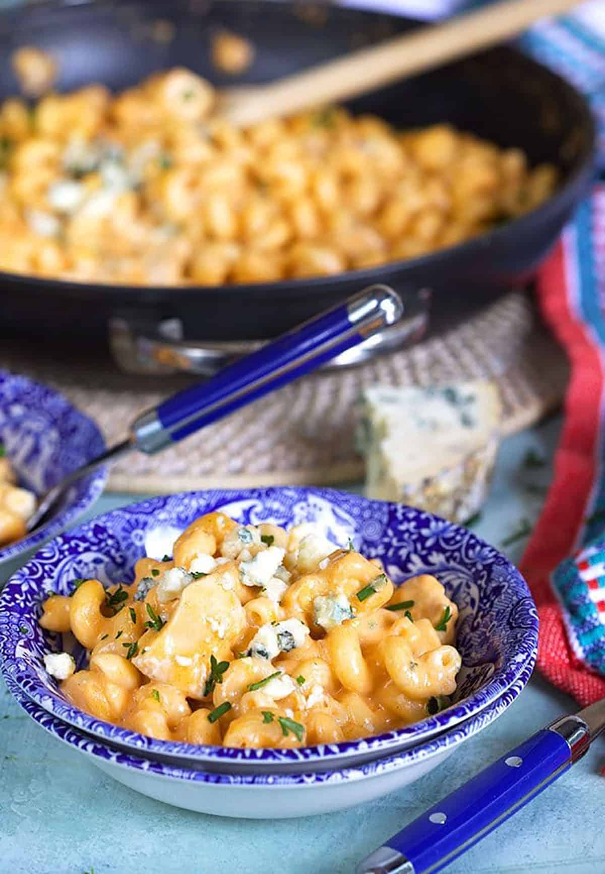 Buffalo Chicken pasta in a small blue and white bowl.