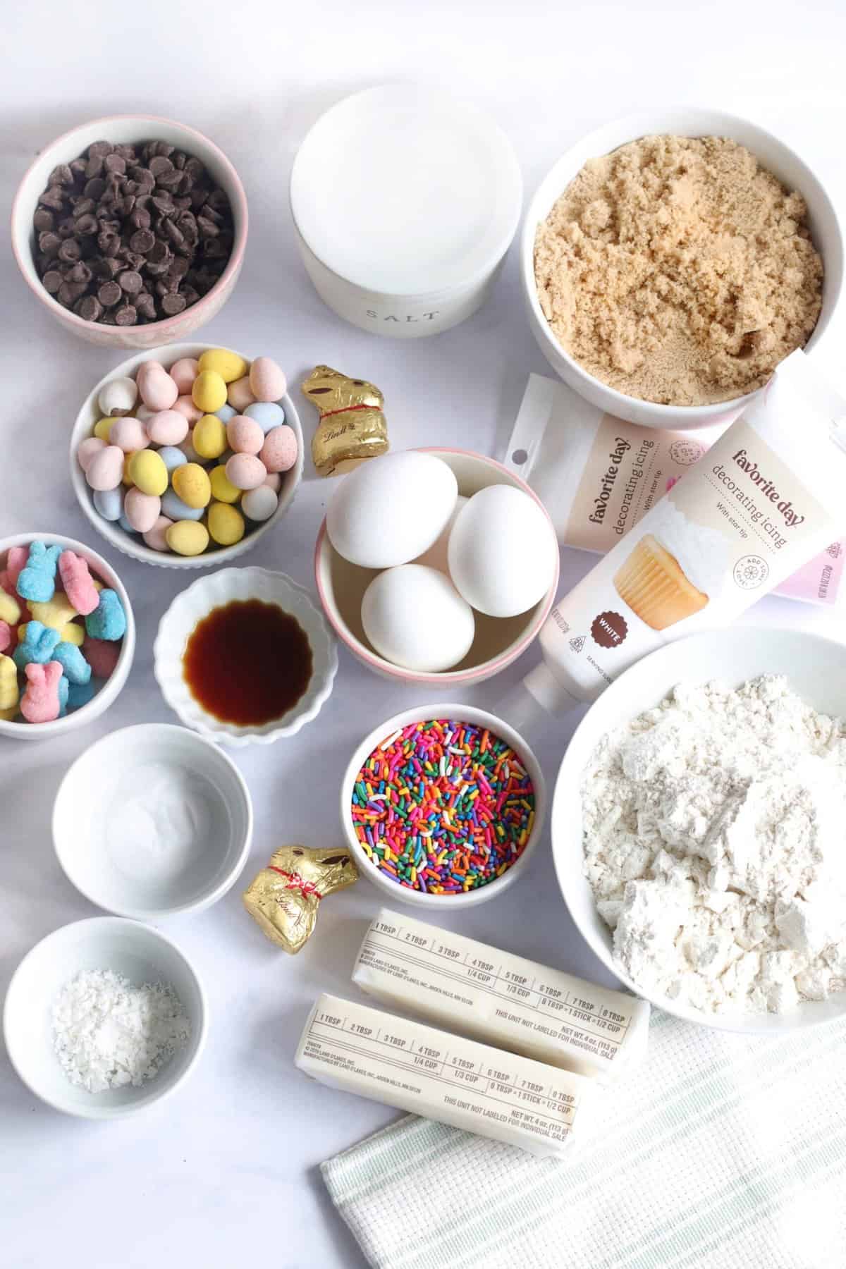 The ingredients for Easter cake are presented on a white countertop. 