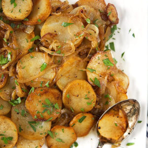 Lyonnaise potatoes on a square platter.