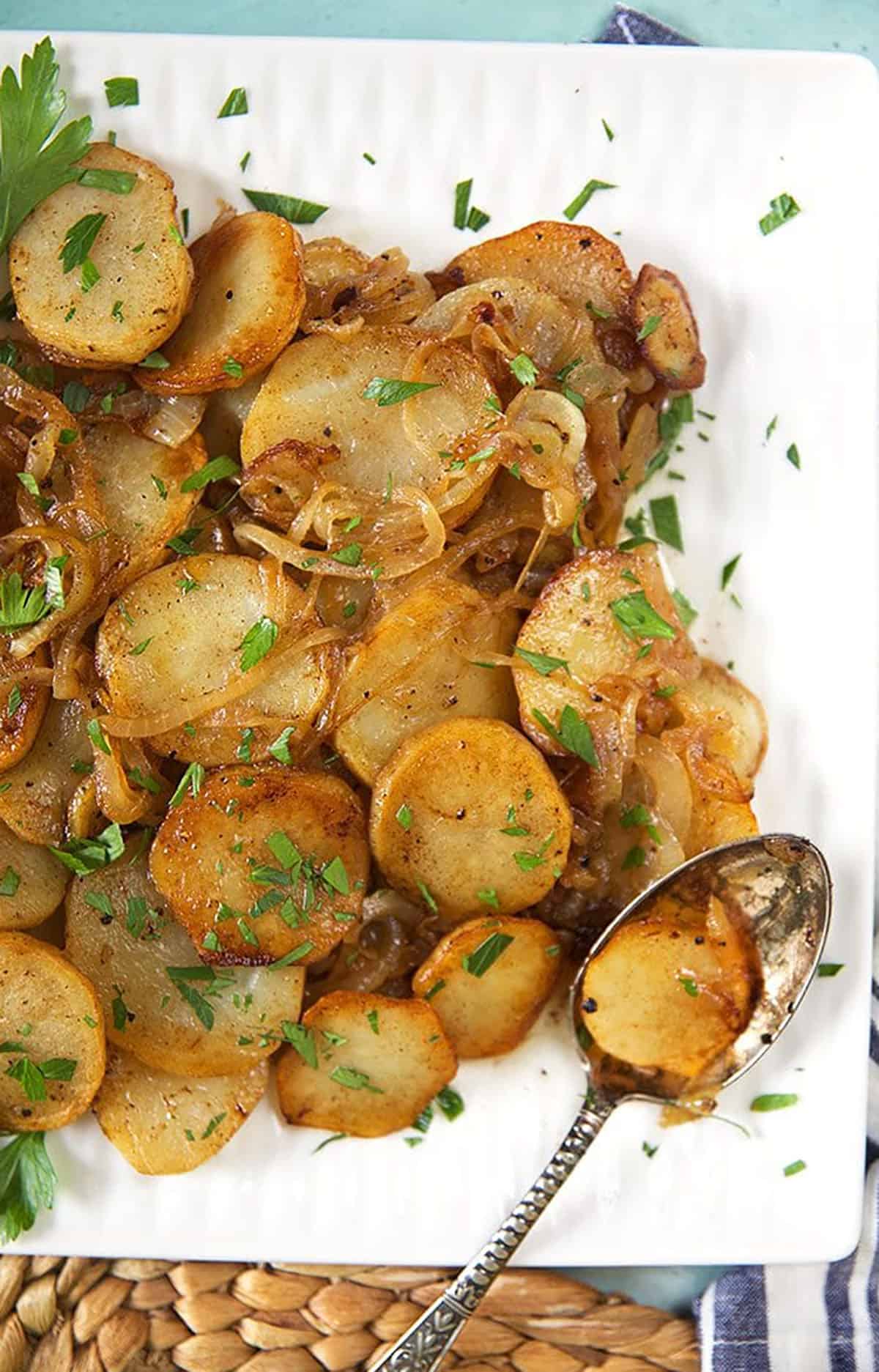 Lyonnaise potatoes on a square platter.