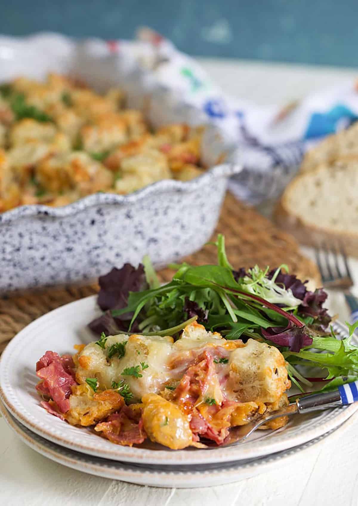 Reuben Casserole on a plate with a casserole dish in the background.