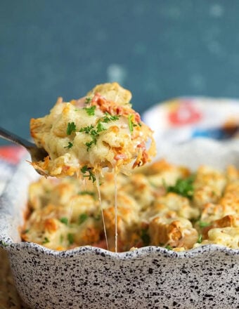 Reuben casserole being served with a spatula from a baking dish.