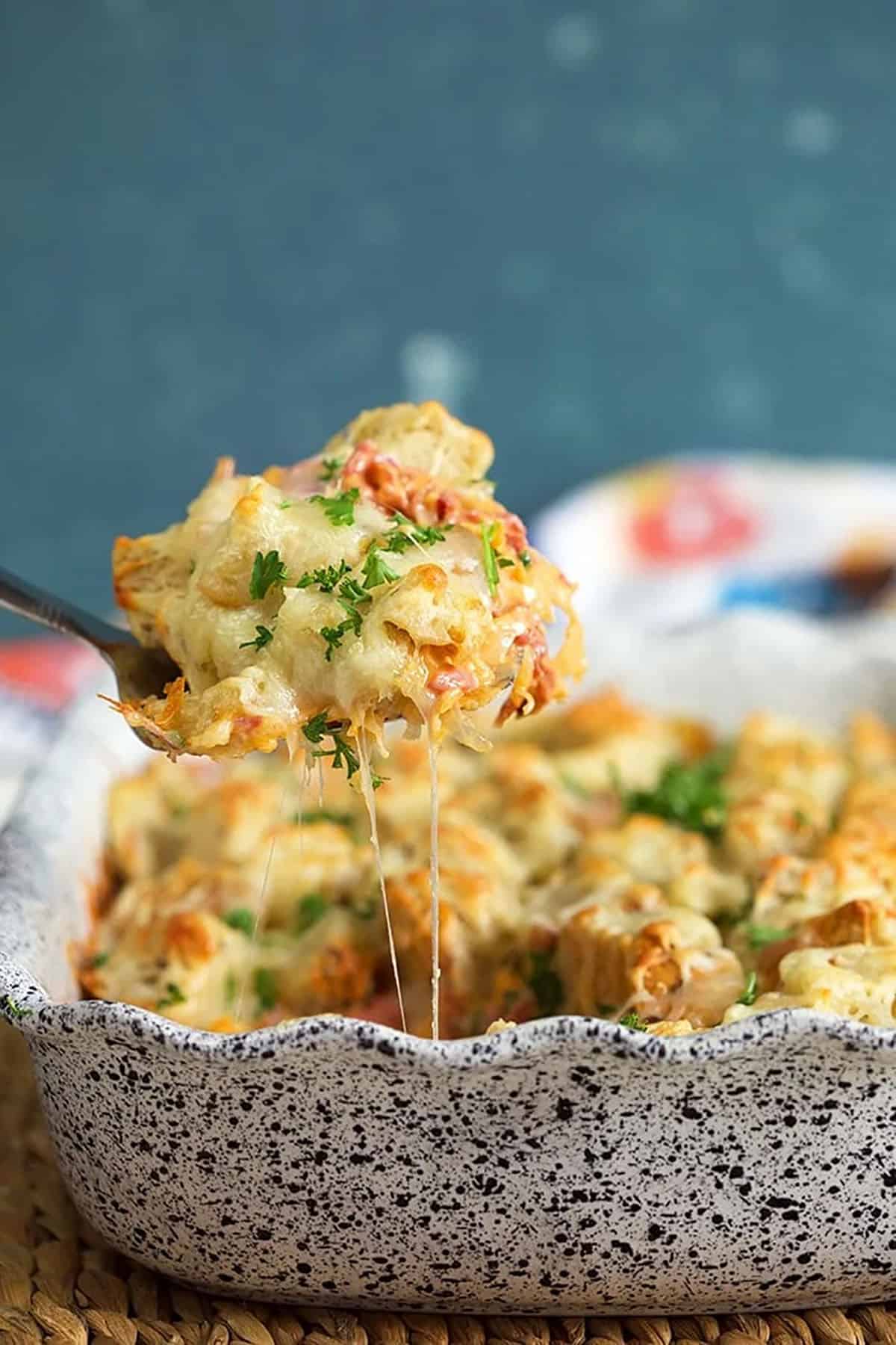 Reuben casserole being served with a spatula from a baking dish.