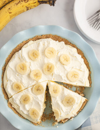 A slice of banana cream pie is still in the pie dish.