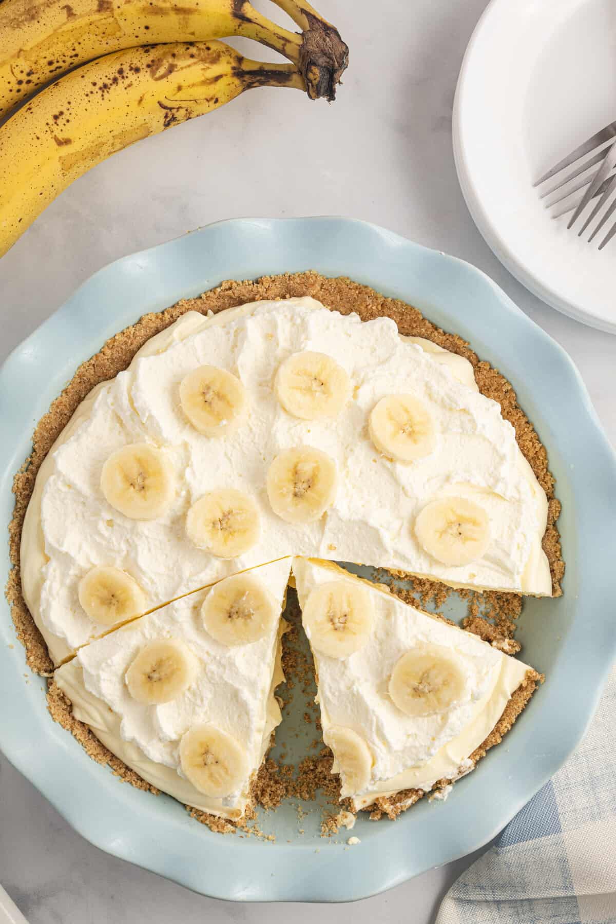 A slice of banana cream pie is still in the pie dish.