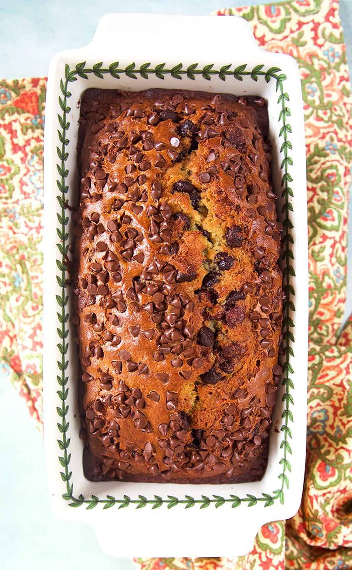Chocolate Chip Banana Bread in a ceramic loaf pan.