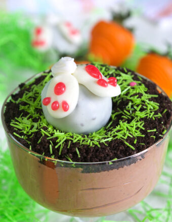 A white bunny butt truffle is placed on top of an Easter pudding dirt cup.