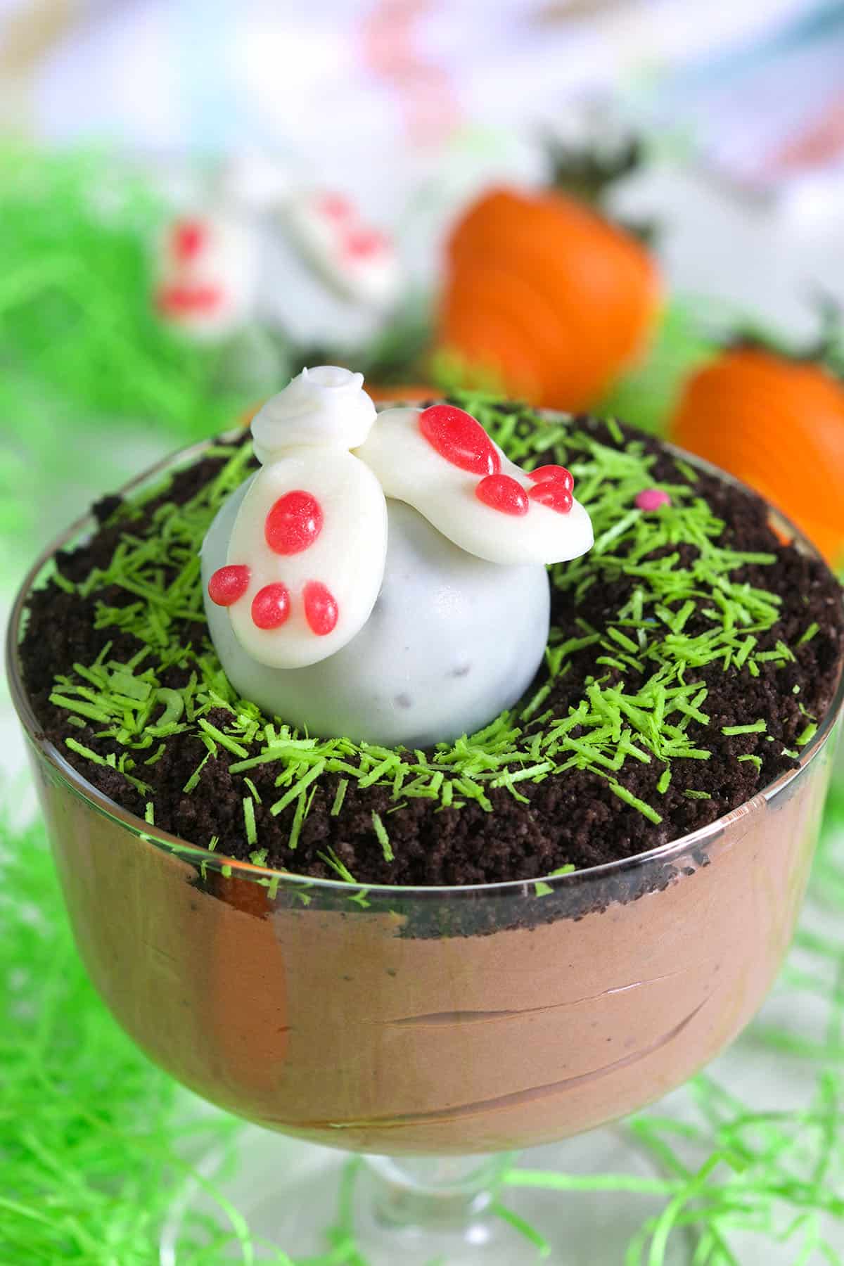 A white bunny butt truffle is placed on top of an Easter pudding dirt cup.