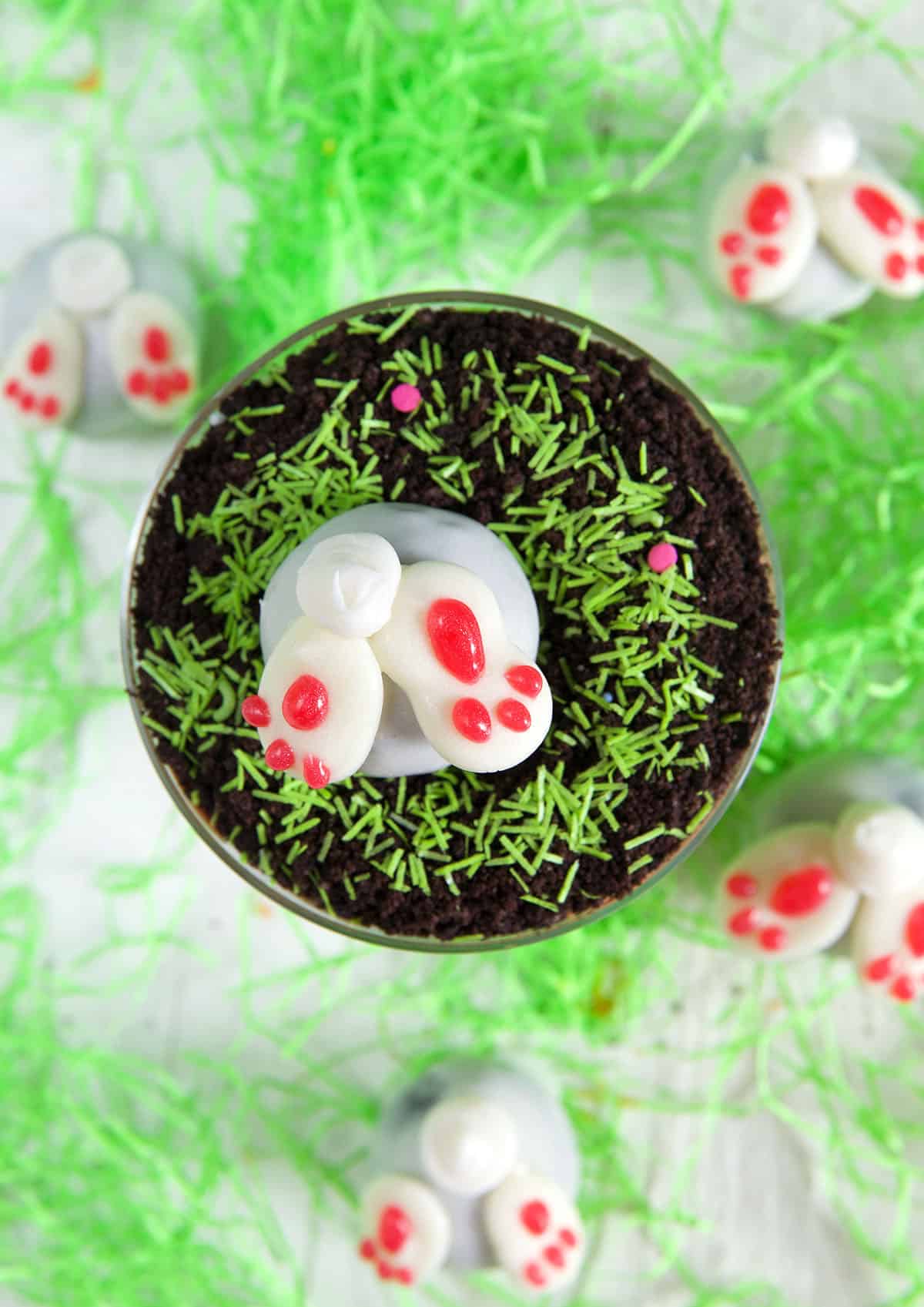 A cup filled with Easter dirt pudding is topped with a bunny truffle.
