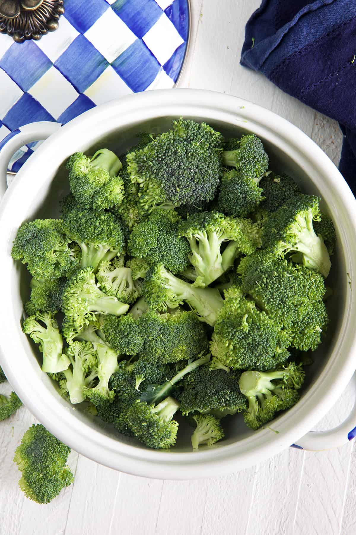 A bowl is filled with uncooked broccoli.