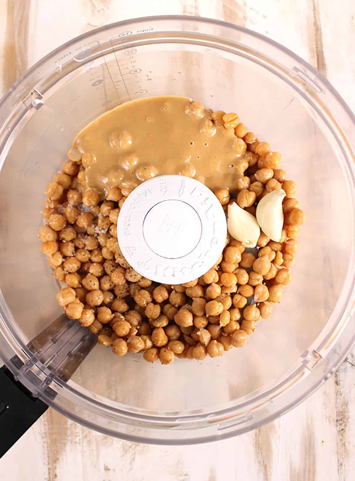 Ingredients for homemade hummus in a food processor