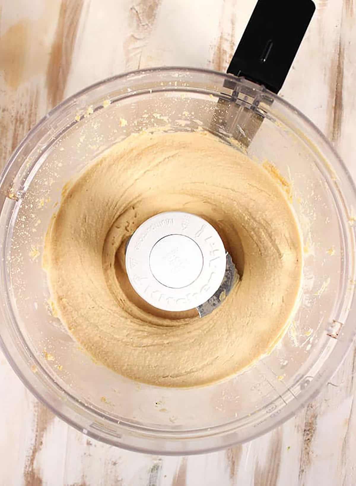 Hummus in a bowl of a food processor