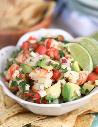 Easy Shrimp Ceviche in a white bowl with limes