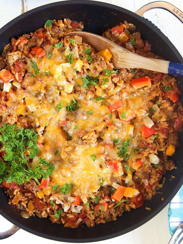 Overhead shot of stuffed pepper casserole in a black skillet.