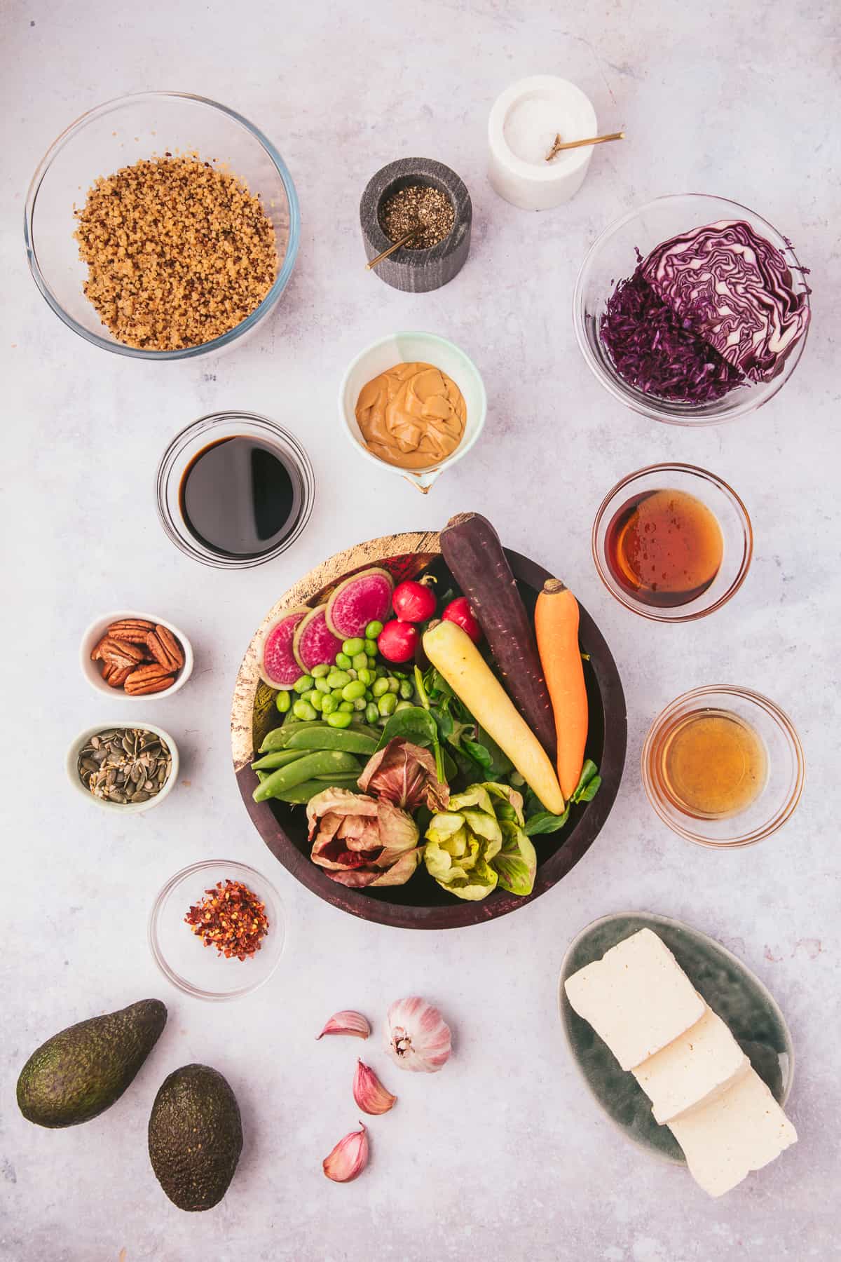 The ingredients for vegan buddha bowls are placed on a white surface.