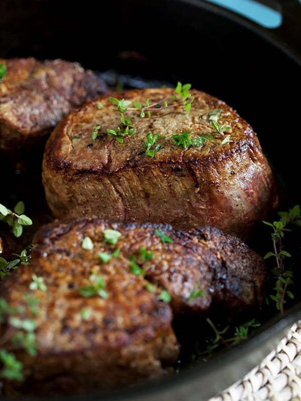 Filet Mignon in a cast iron skillet with parsley on top