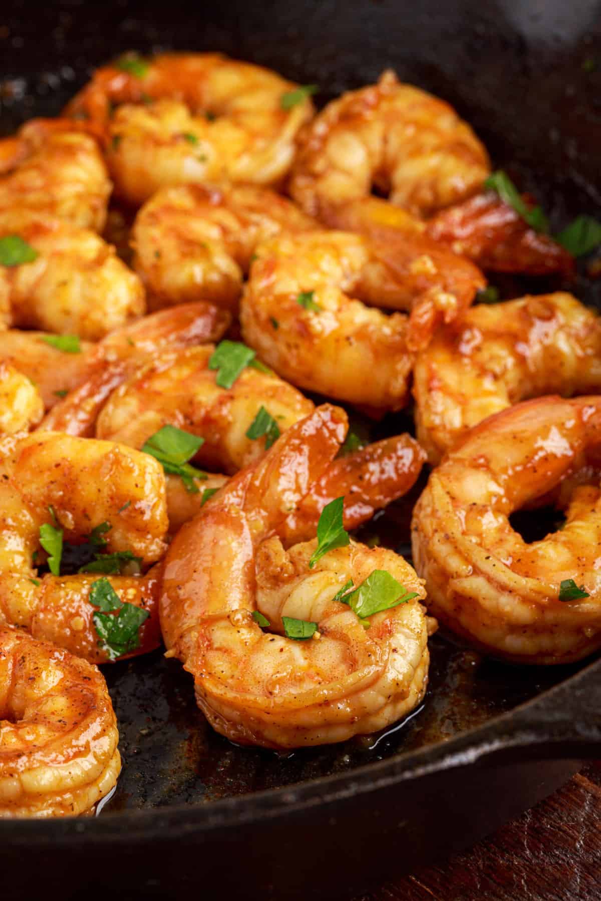A pan is filled with cooked shrimp.