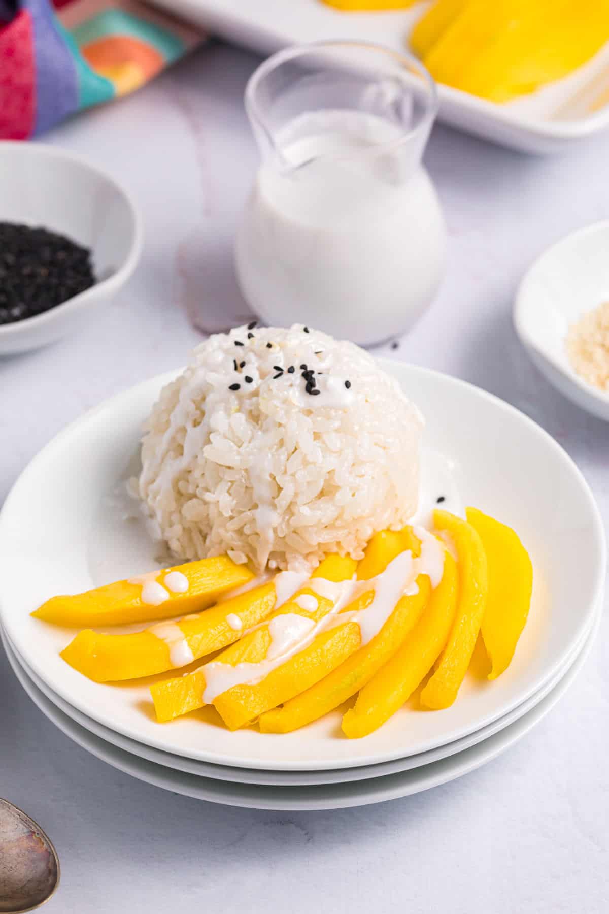 Several slices of mango are placed next to a scoop of white rice.