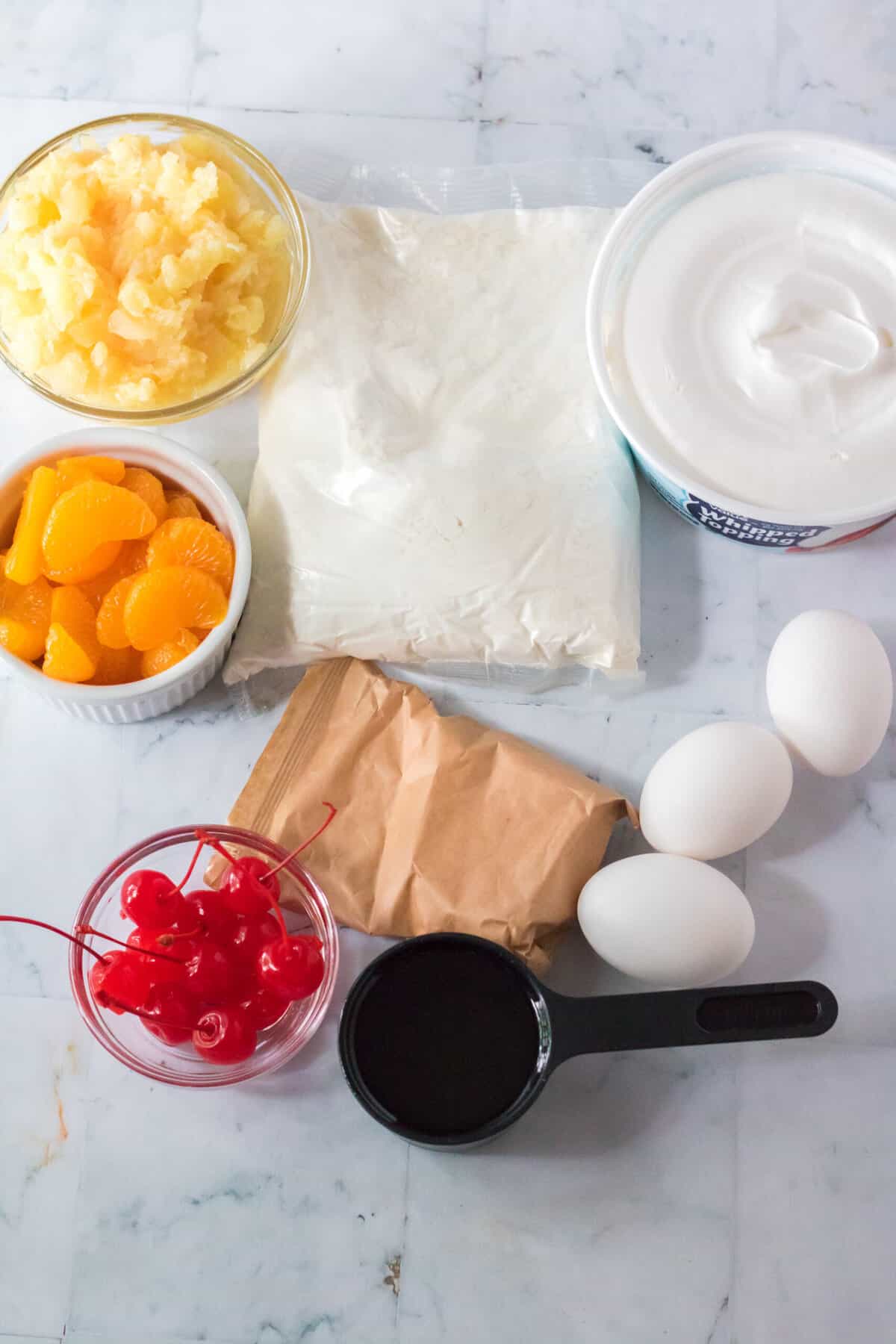 The ingredients for pig pickin cake are spread out across a countertop.