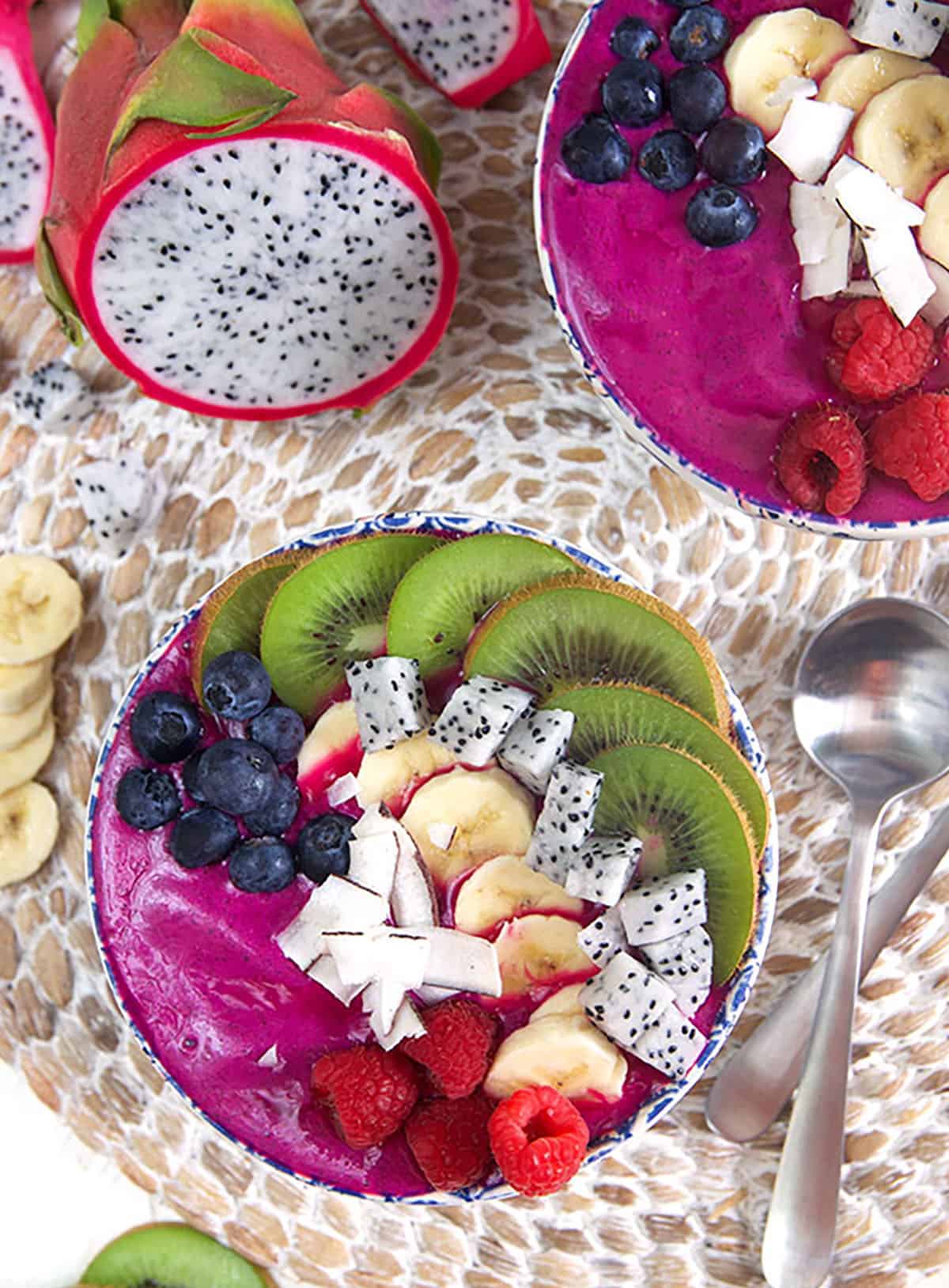 smoothie bowls with a dragon fruit cut in half.