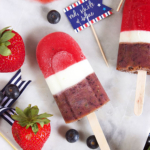 Red white and blue popsicle on a serving tray with a strawberry