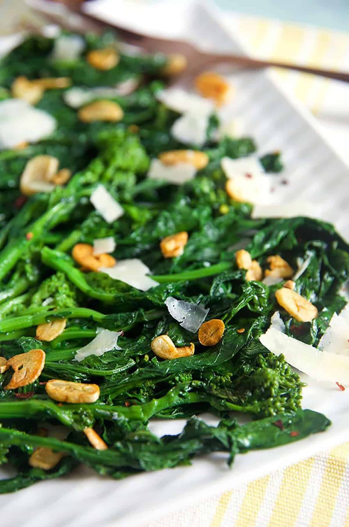 Broccoli Rabe with garlic on a white platter.