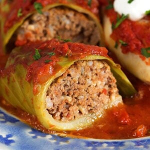 close up of the inside of a stuffed cabbage roll on a blue plate.