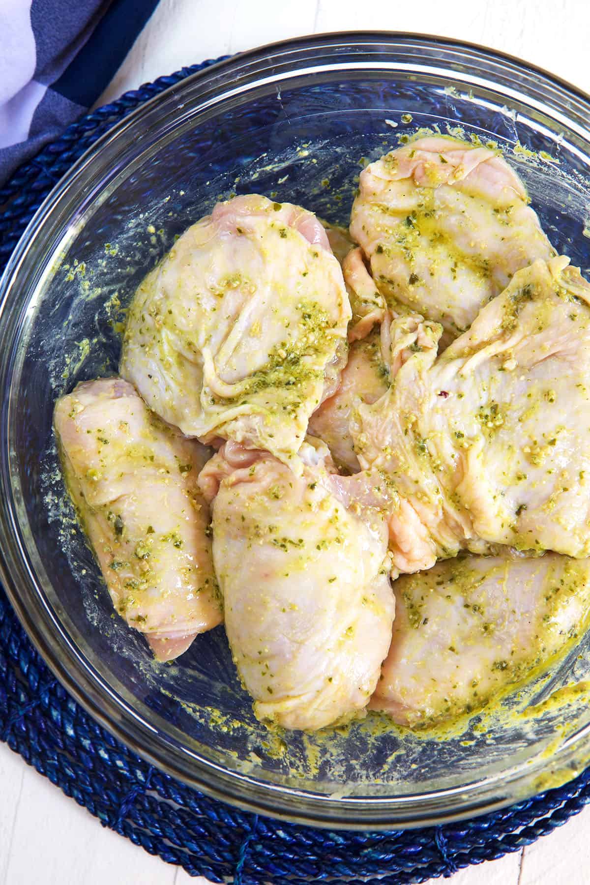 Chicken thigs are tossed in a pesto marinade. 