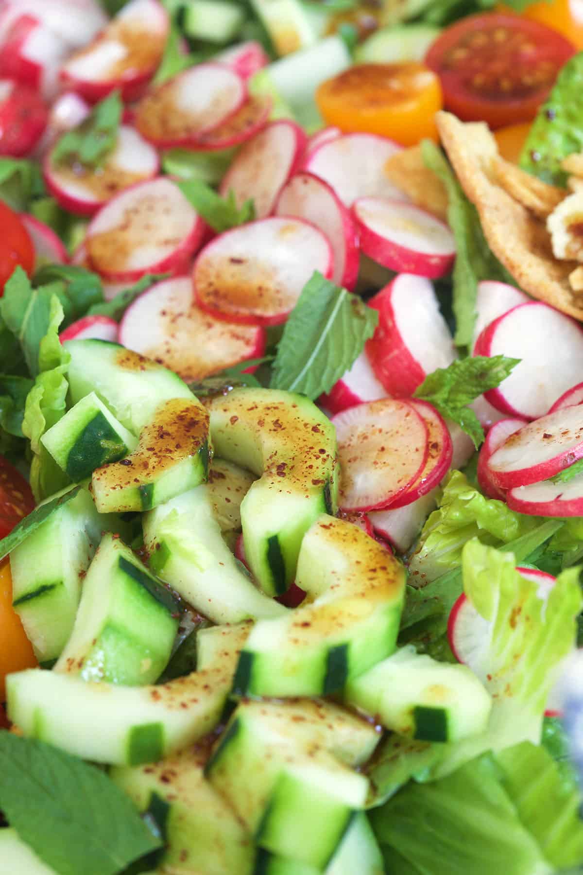 Fattoush salad is topped with dressing.