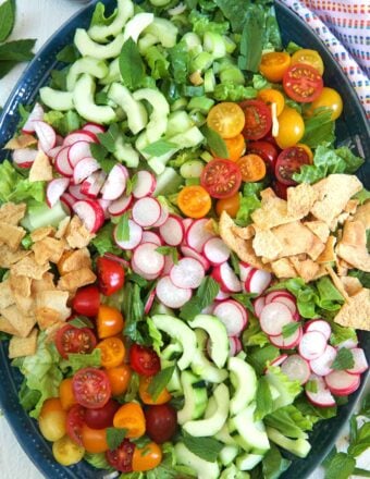 The ingredients for fattoush salad are all placed in a large salad bowl, but are not tossed together.