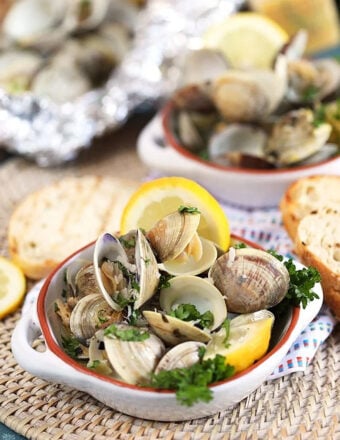 Grilled clams with grilled bread and lemons.