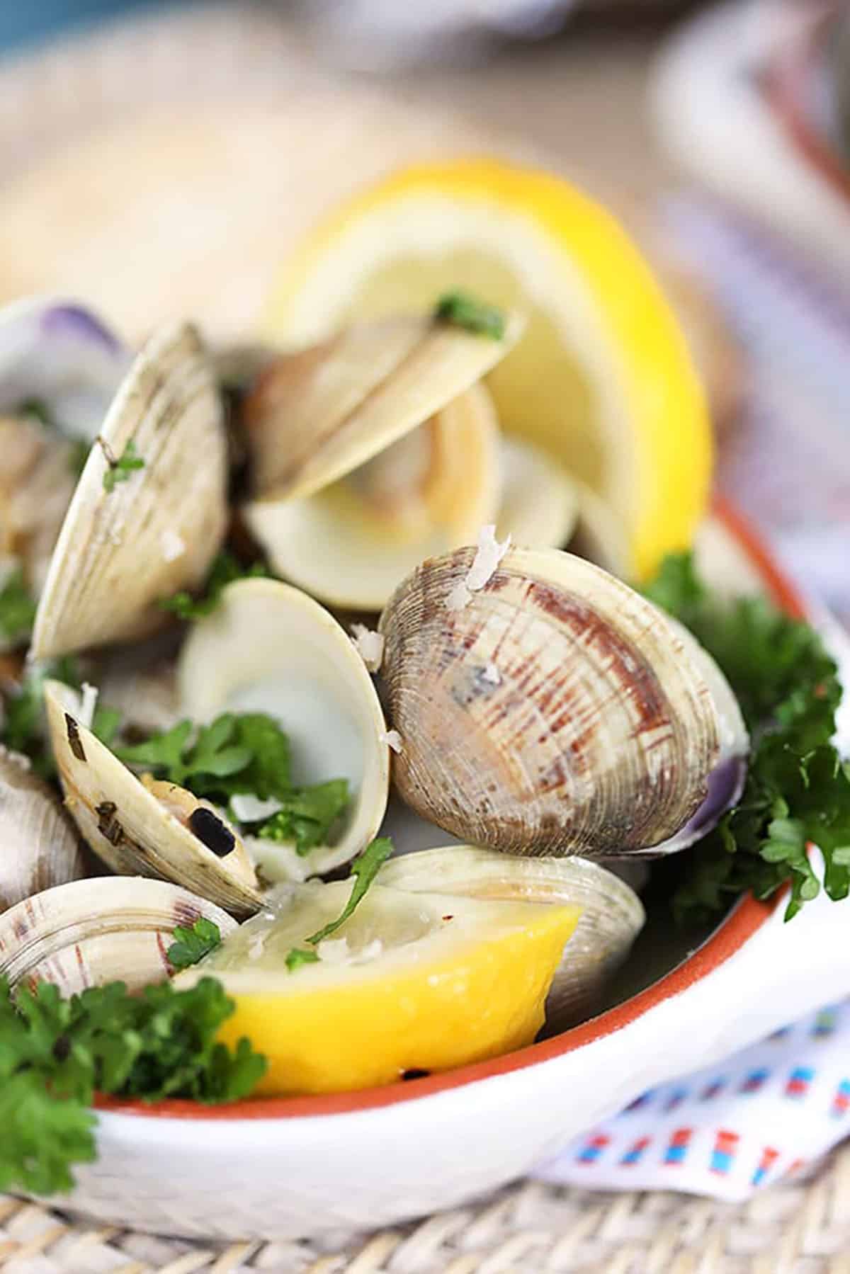 Close up of grilled clams with lemon and basil 