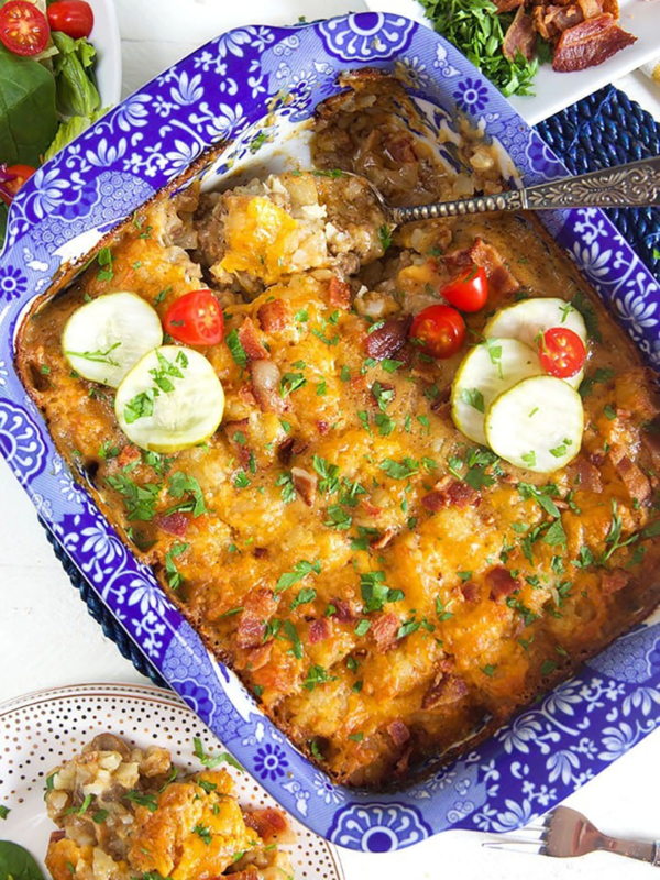 Overhead shot of tater tot casserole hotdish in a blue and white casserole dish.