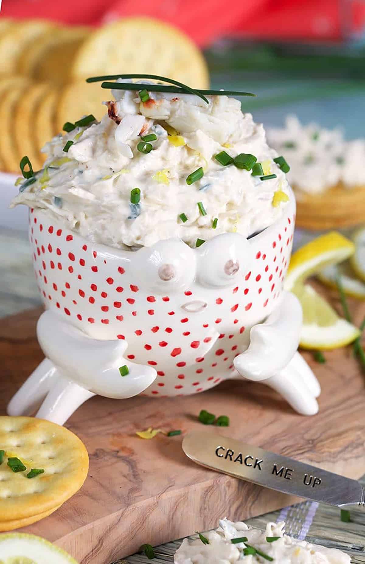 Crab dip in a crab bowl with crackers.