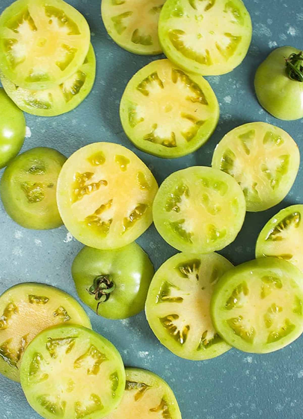 photo of sliced green tomatoes on a blue