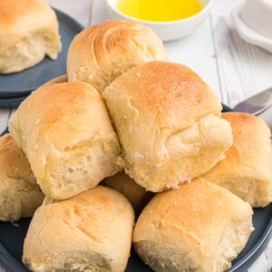 Rolls are stacked on top of one another on a plate.
