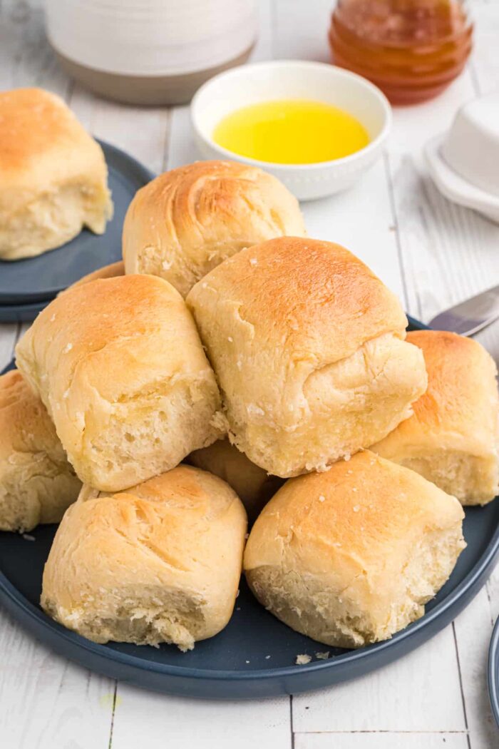 Rolls are stacked on top of one another on a plate.