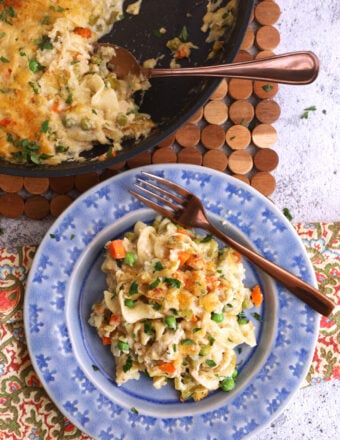 Overhead view of tuna noodle casserole in bowl and skillet