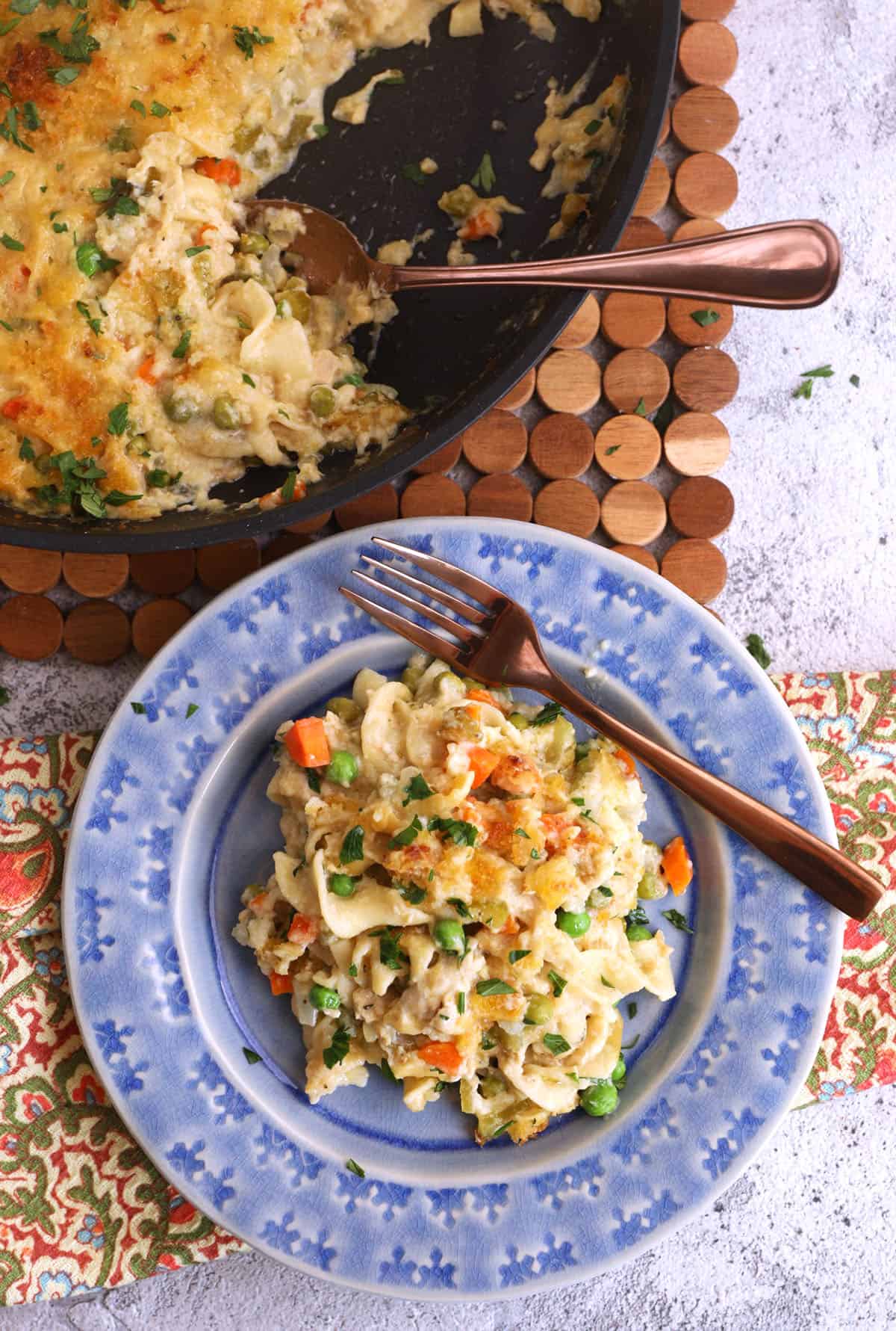 Overhead view of tuna noodle casserole in bowl and skillet