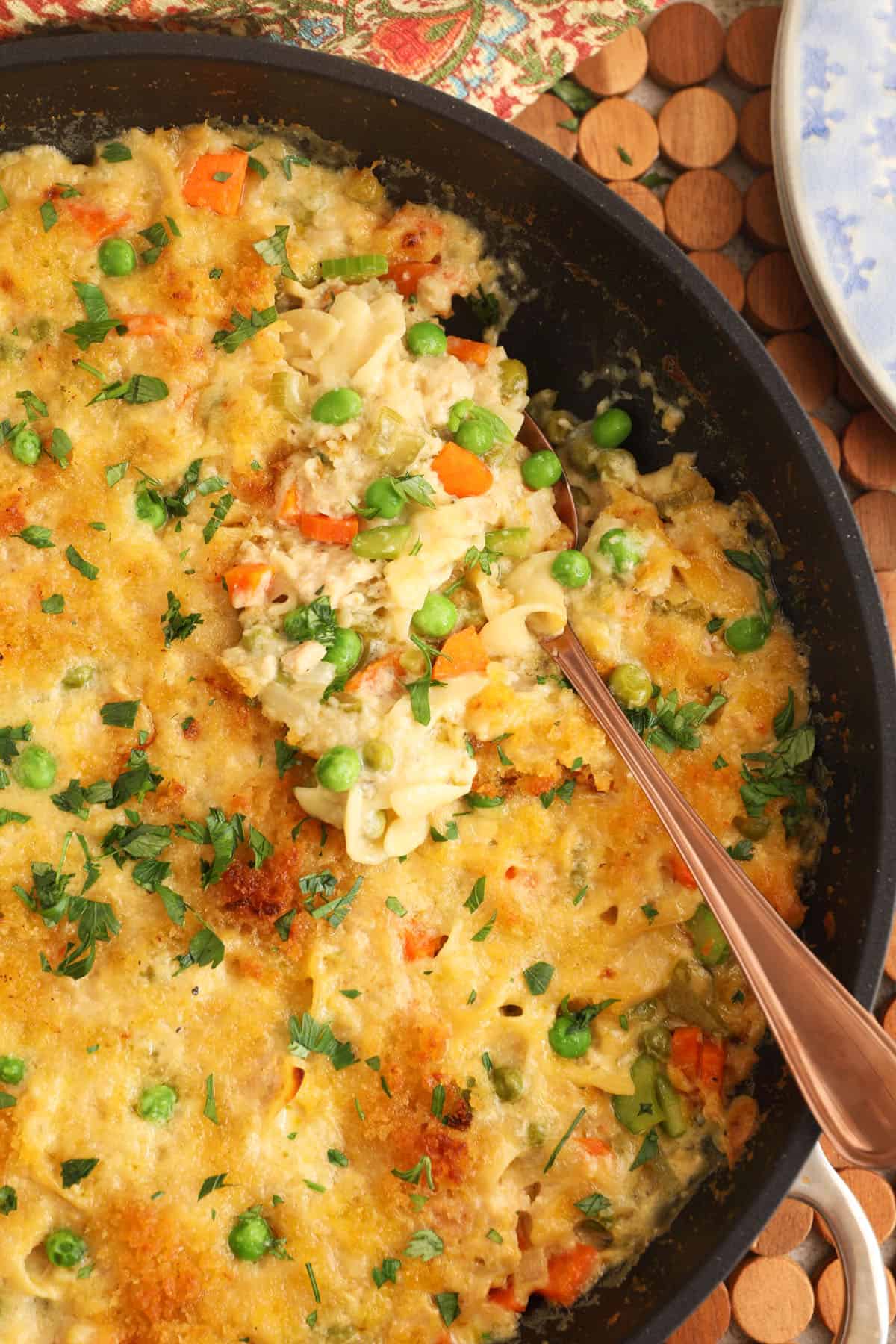 Overhead view of tuna noodle casserole in skillet with spoon