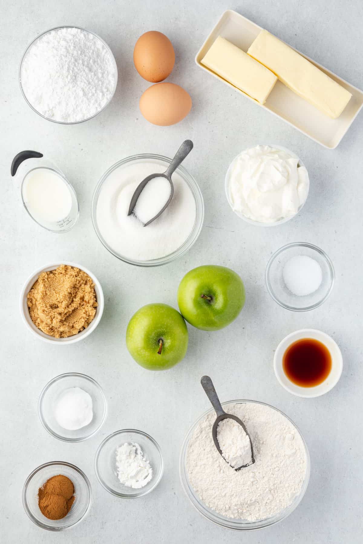 The ingredients for the muffins are placed on a white countertop. 