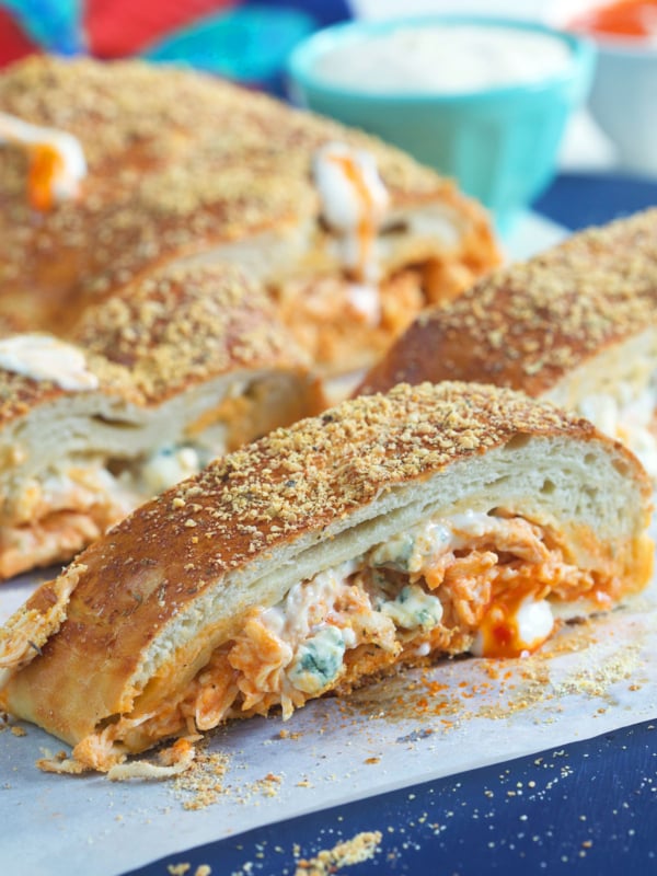 Slices of stromboli are placed on a sheet of parchment paper.