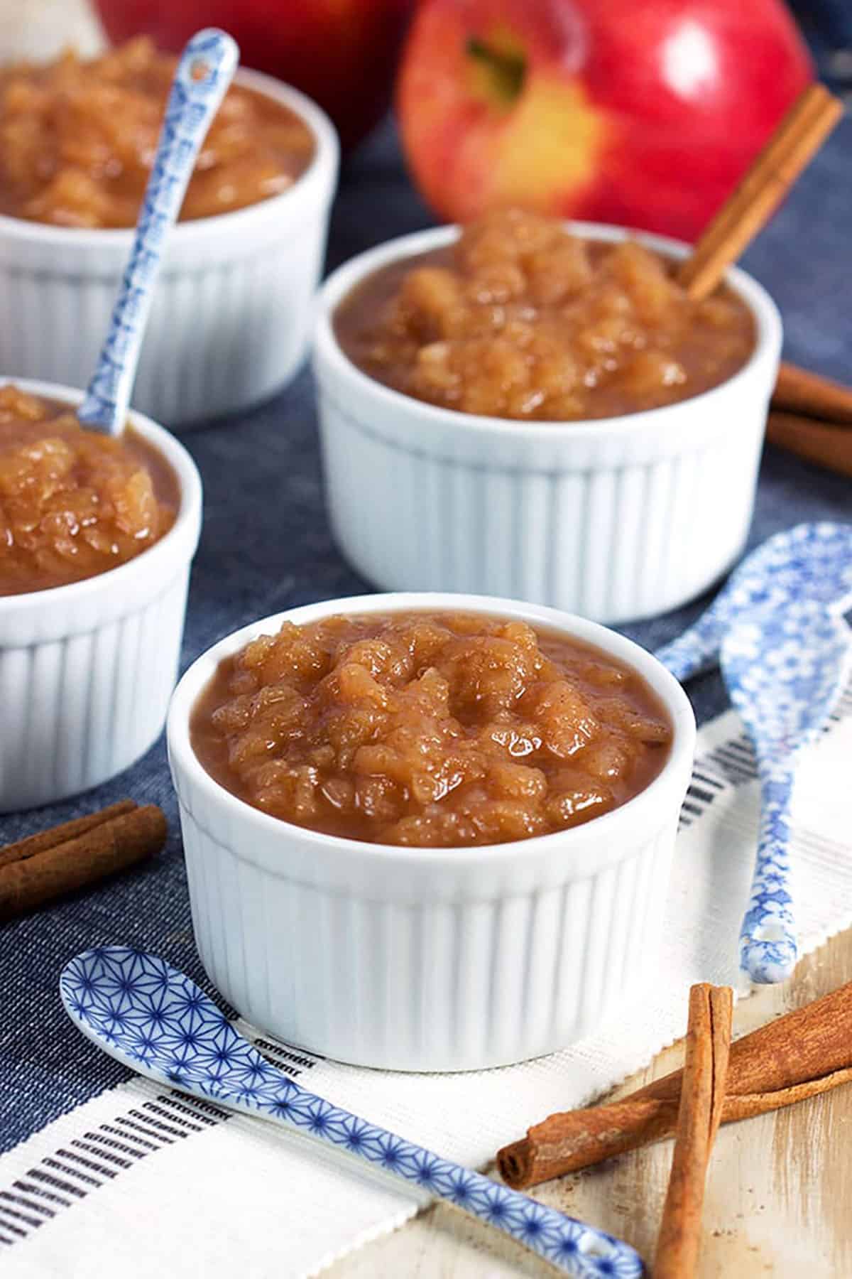 applesauce in a white dish with a blue and white spoon.