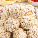A pile of popcorn balls is presented on a tray.