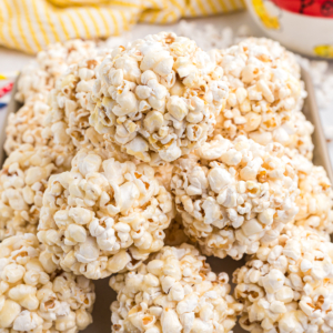 A pile of popcorn balls is presented on a tray.