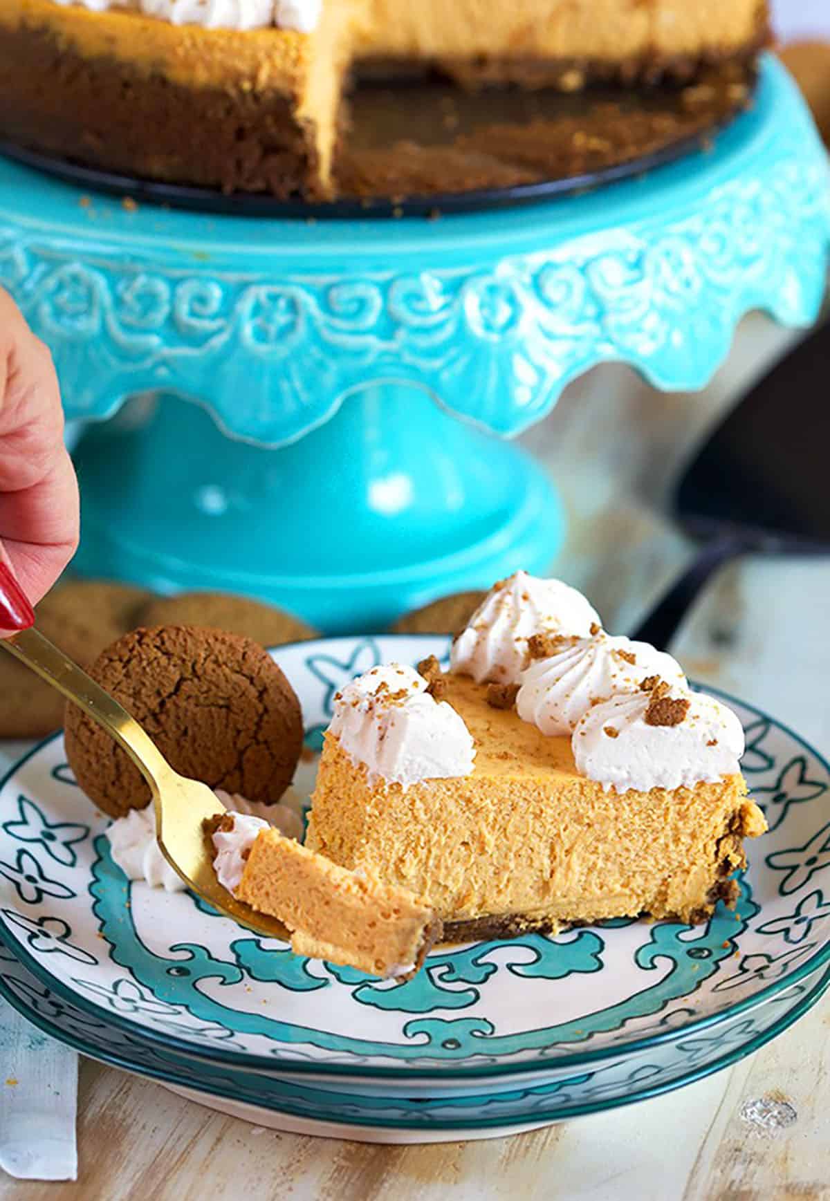 Pumpkin Cheesecake with a bite on a golden fork.