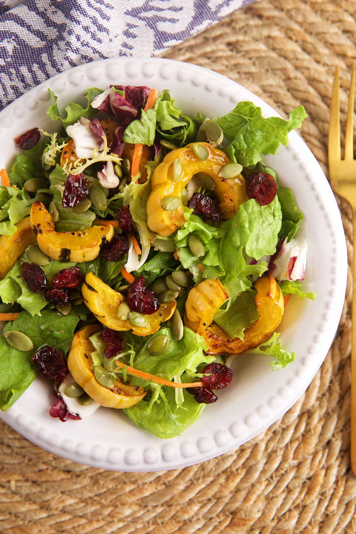 Bowl of delicata squash with salad greens