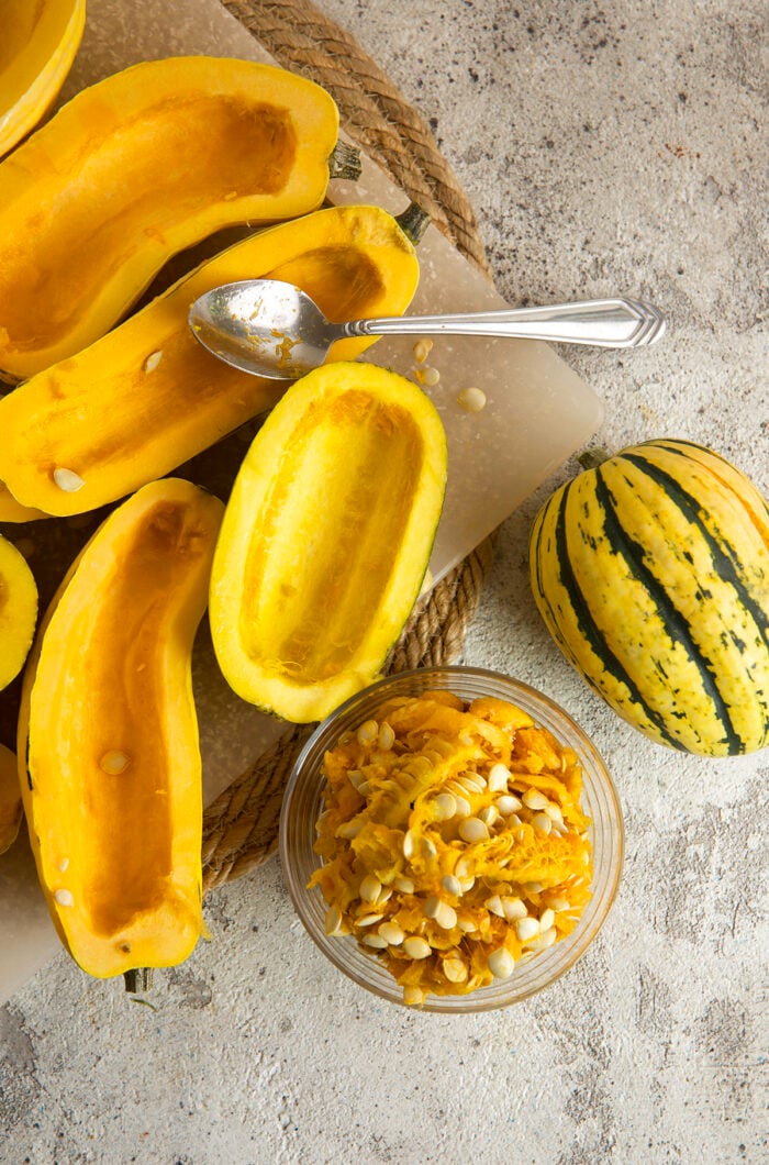 Scooping seeds and pulp from delicata squash