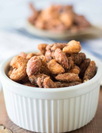 A small white ramekin is filled with candied nuts.